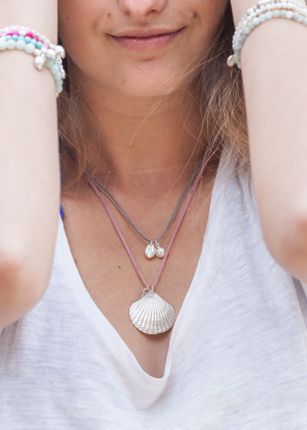 Handmade silver scallop shell and cowrie shell necklaces by Helen Butler Designs inspired by nature, movement and coastal surroundings