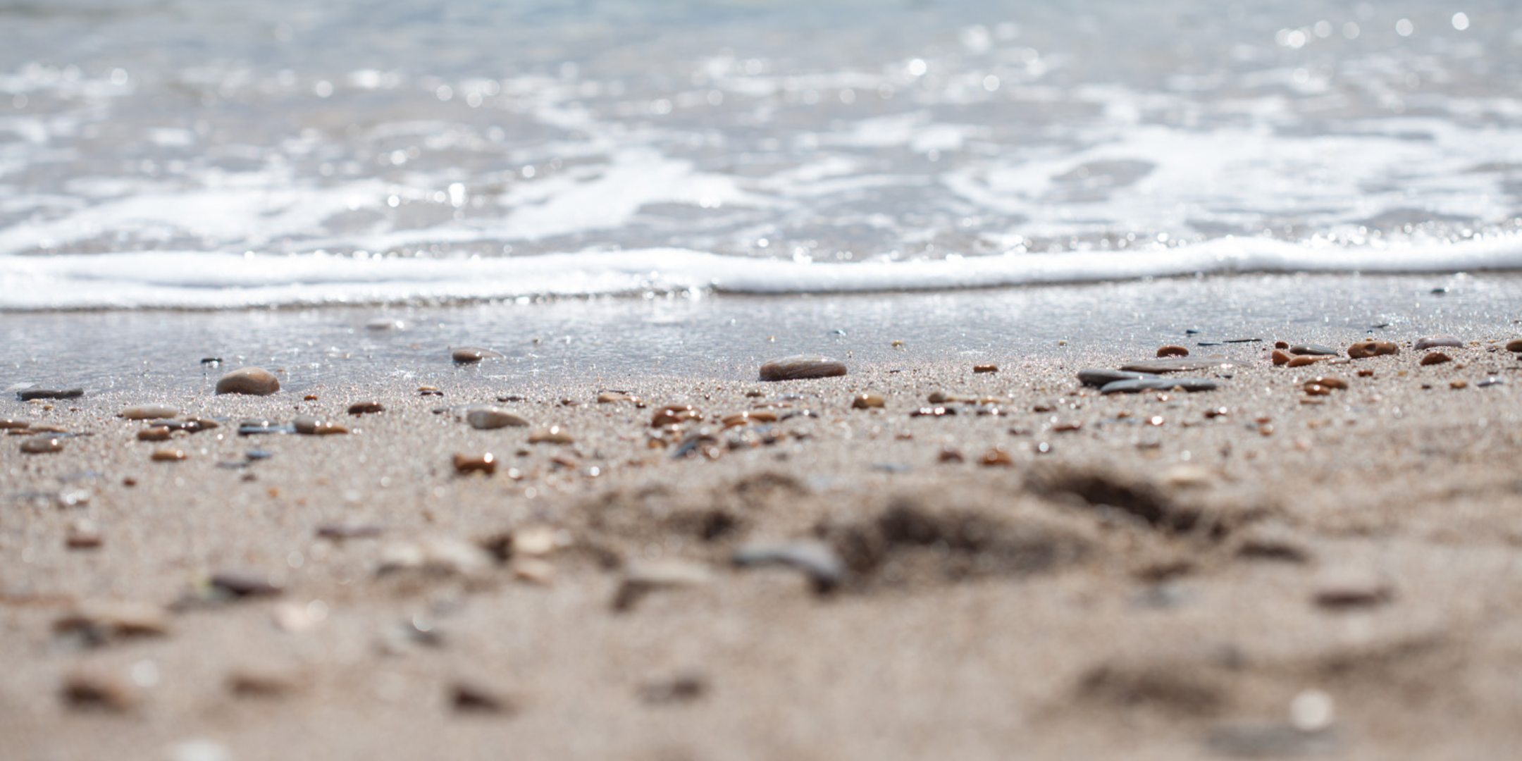 Waves washing onto the shoreline at Slapton Sands, reflecting the coastal inspiration behind Helen Butler Designs