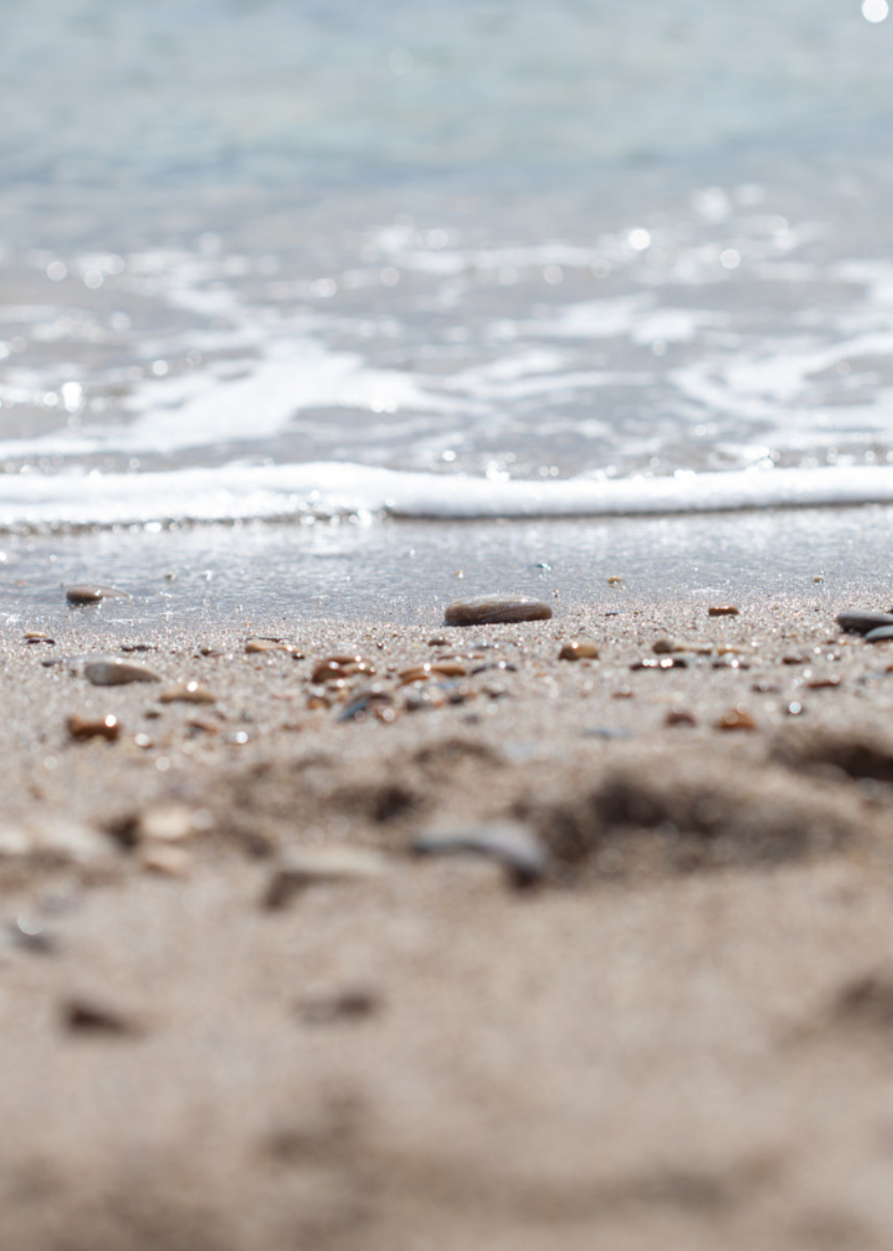 Waves washing onto the shoreline at Slapton Sands, reflecting the coastal inspiration behind Helen Butler Designs