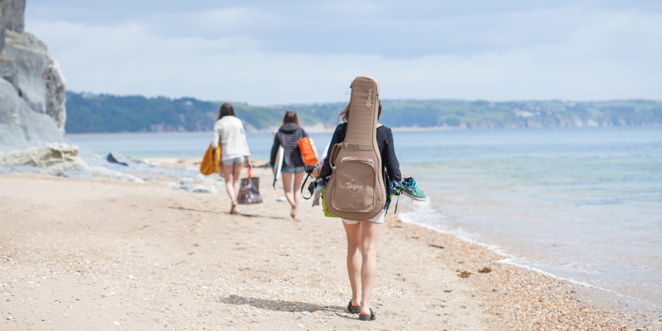 Walking along Slapton Sands beach at Torcross, reflecting the coastal lifestyle and inspiration behind Helen Butler Designs