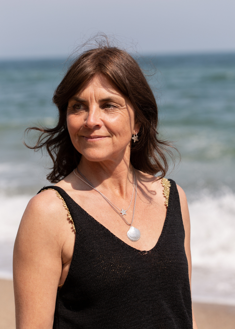 Helen Butler wearing handmade silver jewellery inspired by the Devon coast and coastal life