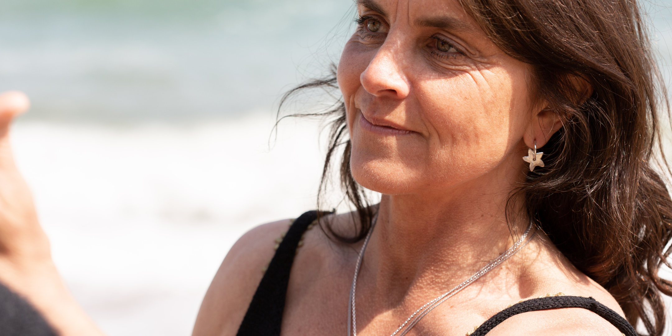 Helen Butler wearing handmade silver jewellery inspired by the sea and South Devon coastline